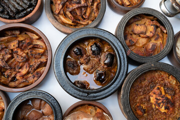 traditional turkish food in pottery. pottery kebabs on white background top view