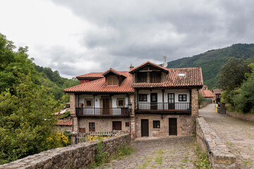 Fototapeta na wymiar Stone houses and narrow streets in a mountain village in the north of Spain. barcena mayor