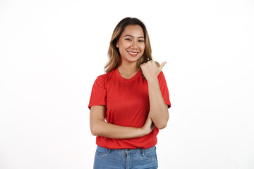 Studio shot of pretty Asian woman with red t-shirt isolated on white background. Pointing blank area