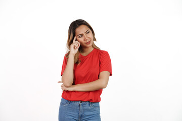 Studio shot of pretty Asian woman with red t-shirt isolated on white background. Thinking