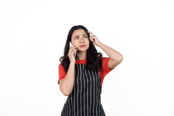 Obraz na płótnie Canvas Call mobile phone, Food shop owner concept, Smiling young confident asian woman in black apron and red t-shirt isolated on white background.