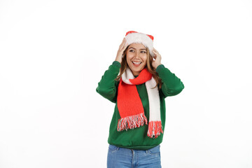 Attractive excited asian female in green sweater with santa hat on christmas isolated on white background.