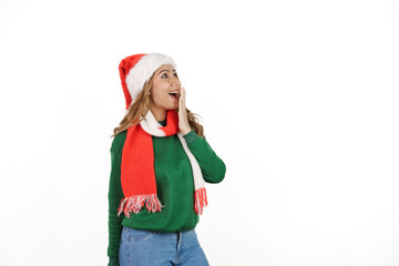 Attractive excited asian female in green sweater with santa hat on christmas isolated on white background.