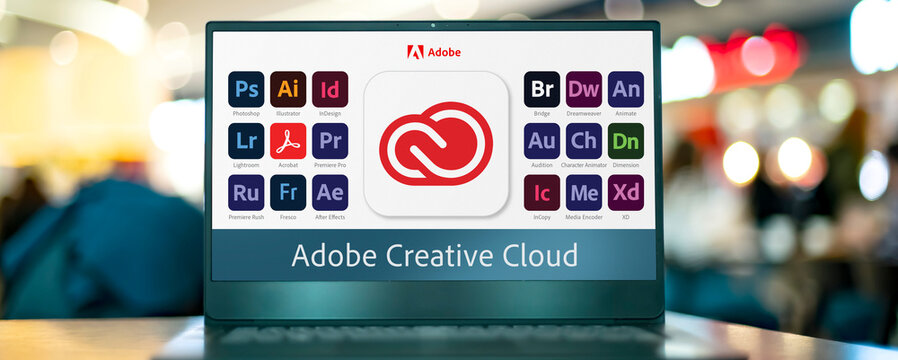 Laptop computer displaying logotypes of Adobe Creative Cloud