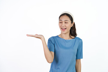 Beautiful Asian woman in blue t-shirt isolated on white background. Palm up