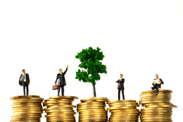 Business Money and Financial Concept. four businessman miniature people figure and green tree...