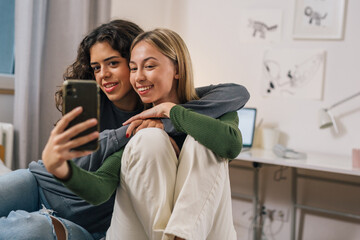 two good friends take a picture together on the phone