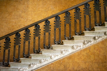 Magnificent marble staircase photographed from the side leads diagonally upwards in front of a...