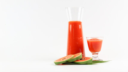 Papaya smoothie in glass jar and glasses on white background diet vegetarian healthy and freshness drink concept soft and selective focus
