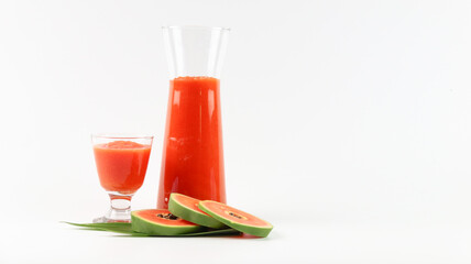 Papaya smoothie in glass jar and glasses on white background diet vegetarian healthy and freshness drink concept soft and selective focus
