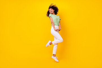 Fototapeta na wymiar Full body size photo of young adorable nice perfect girl folded hands shy dance positive look curious empty space isolated on bright yellow color background
