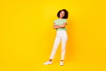 Full size photo of young adorable pretty nice girlish lady folded hands toothy positive smile confident business owner ad isolated on yellow color background