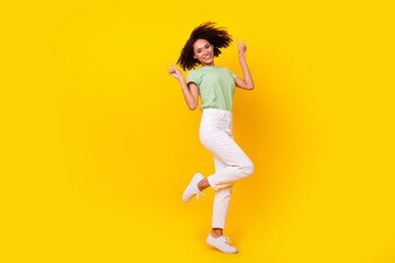 Fototapeta na wymiar Full body size photo of young pretty attractive nice woman showing v-sign symbol toothy smile dance pose isolated on yellow color background