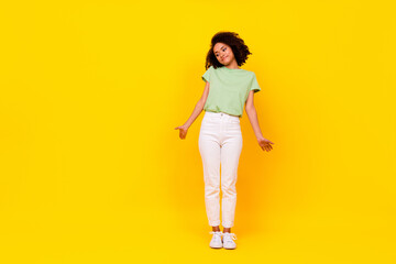Full size photo of young attractive gorgeous nice woman wear green t-shirt look down palms no idea isolated on bright yellow color background