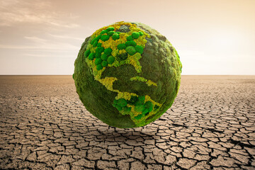 Green planet earth on desert. Symbol of global warming and climate change