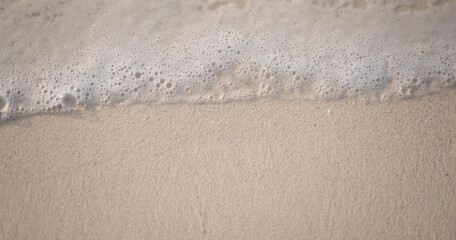 beach during sunset wave on a sandy beach