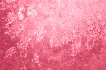 Textured frosty pattern on window lit by winter sun as background in color 2023 Viva Magenta.