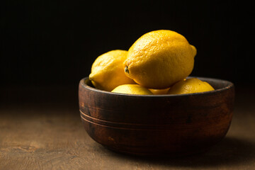 juicy yellow citrus fruits in a bowl