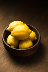 A lemons, juicy citrus fruits in a bowl