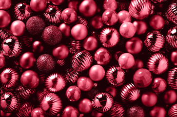 Shiny viva magenta Christmas balls as holiday background. Trendy color of the Year 2023.