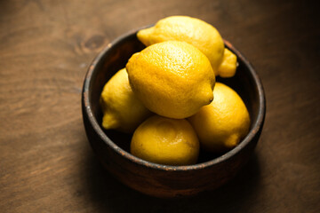 A lemons, juicy yellow fruits in a bowl