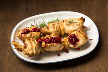 Chicken kebab and lingonberry sauce on a dark background