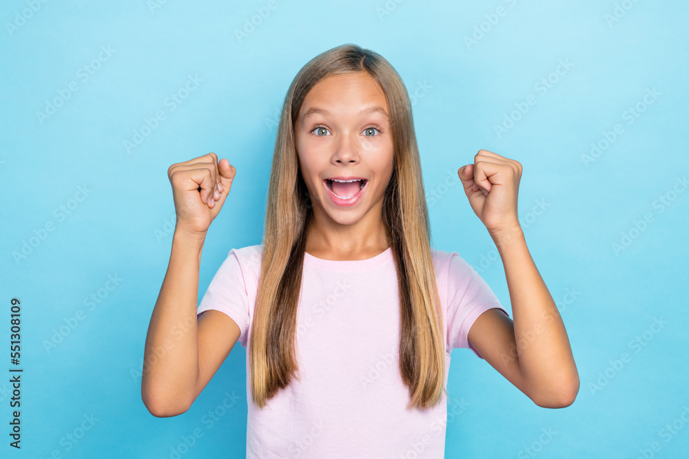 Sticker photo of delighted positive girl raise fists triumph accomplishment isolated on blue color backgroun