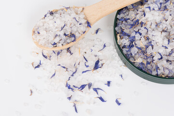 Obraz na płótnie Canvas bath salts and blue dried flowers top view