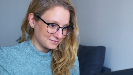 Woman tutor works online with student at laptop. Woman conducts an online lesson, teaches her subject and carefully listens to the student's answer to a question on the topic of the lesson, nodding.