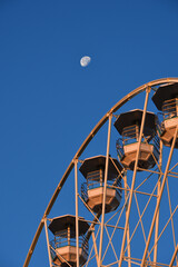 Switzerland, Geneva. Early morning moon and Ferris wheel. August 16, 2022.