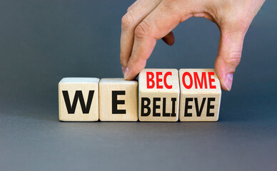 We become or believe symbol. Concept word We believe We become on wooden cubes. Beautiful grey table grey background. Businessman hand. Business we become or believe concept. Copy space.