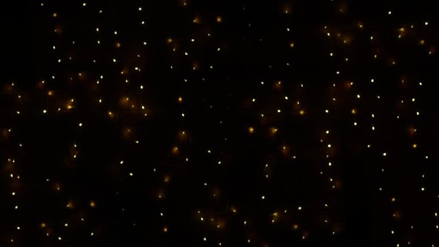 Christmas lights flashing gold texture against brick wall texture