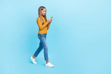 Fototapeta na wymiar Full size photo of cheerful positive girl straight hairstyle dressed yellow turtleneck talk video call isolated on blue color background