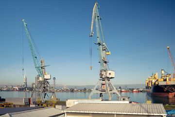 Fototapeta na wymiar Cranes and ship at sea port of Batumi city in Georgia. Logistic, transportation, trading concept