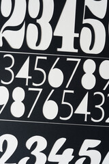 black paper stencils with various number cutouts