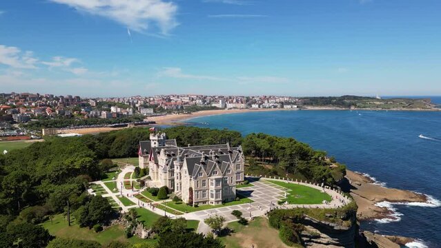 Magdalena Palace in Santander Spain with aerial view of the peninsula and the city with sunny beach in summer. 
