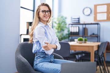 Young blonde woman business worker smiling confident with arms crossed gesture at office