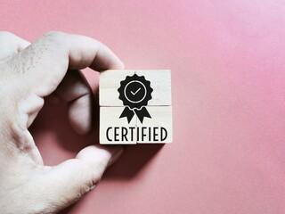 Quality warranty concept with icon on wooden cubes with hand.