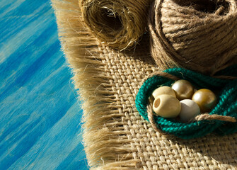 Rope of straw for weaving macrame on a wooden background.