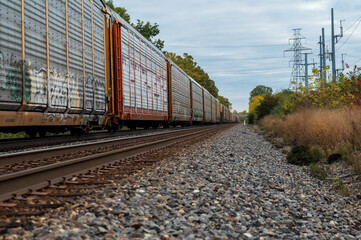 Obraz premium Freight train travelling through rural area in the midwest