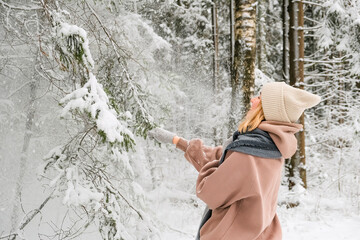 Winter.woman walks through winter snowy forest. Mental and physical health. Unity with nature.travel outdoors, hiking, spending time outdoors,winter travel,slow life,christmas forest.