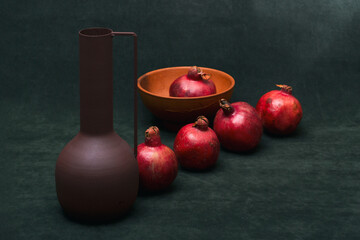 Still life with ripe pomegranates and a vase