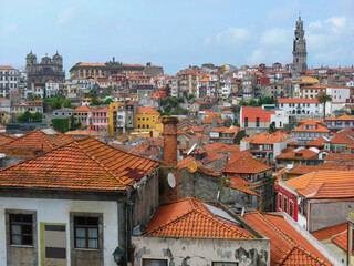 Fototapeta na wymiar High angle view of Porto Oldtown, Red and Orange color tiled roofs and colorful old houses, view from above. Town scape of World Heritage site, Porto Portugal