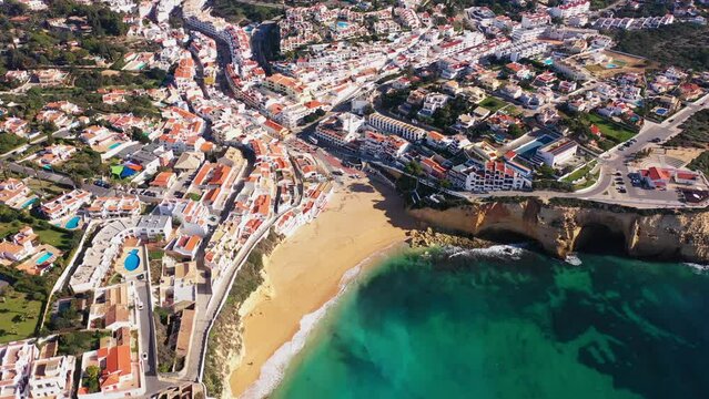 Beautiful aerial views of the seaside tourist town of Carvoeiro with cliff beaches and traditional Portuguese houses.