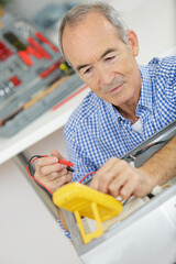 an electrician is checking voltage