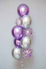 set of purple balloons on wall background