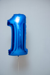 blue balloon foil number one on wall background