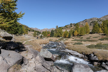 View of Claree river in Claree valley with Massif de Cerces mountains on either site, near Navache village and Briancon, Hautes-Alpes department, France  