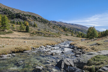Fototapeta na wymiar View of Claree river in Claree valley with Massif de Cerces mountains on either site, near Navache village and Briancon, Hautes-Alpes department, France