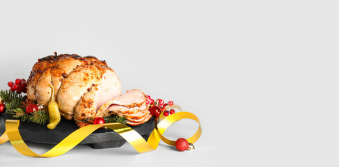 Tasty ham with Christmas decor on light background with space for text